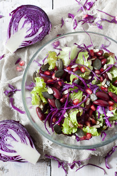 mixed salad on bowl with red beans, seeds and purple cabbage