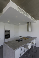 modern kitchen with gray tile floor and white wall