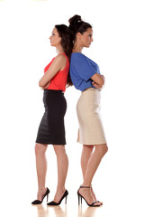 Two angry women leans backs on each other