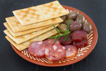 sausages with olives on plate
