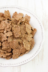flakes in white dish on white background