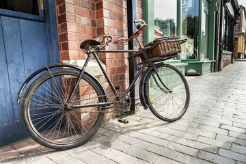 Fototapeta na wymiar Vintage shop bicycle with wicker basket on the front.