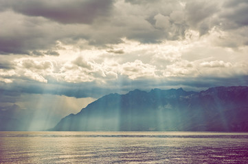 Sun rays falling through heavy clouds on the mountains