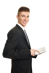 Young businessman writes on the tablet pc