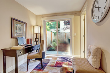Room with office area and exit to backyard