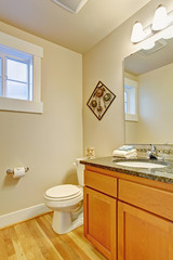 Obraz na płótnie Canvas Restroom with maple vanity cabinet
