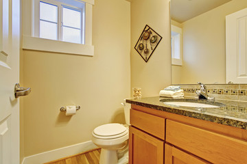 Restroom with maple vanity cabinet