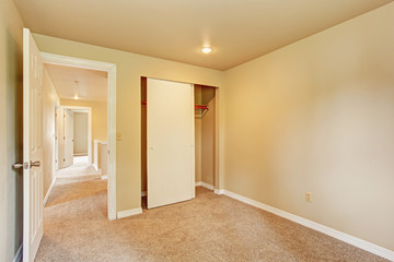 Empty room in soft ivory tones with closet