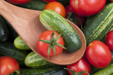 Tomato and cucumber in a wooden spoon
