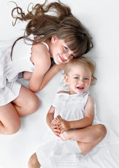 portrait of two sisters in white dresses