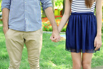 Loving couple holding hands outdoors