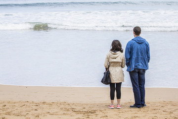 Pareja en la playa mirando al mar