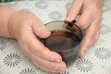 Old Hands Holding A cap of tea