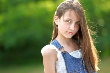 Naklejka premium portrait of little girl outdoors in summer