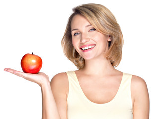 Portrait of a young smiling healthy woman with apple