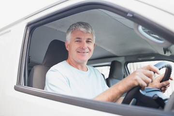 Smiling man driving van