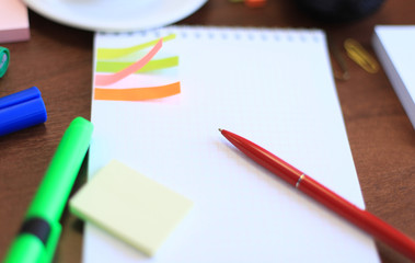 Workspace with coffee cup, note paper on table
