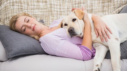 Beautiful blonde on couch with pet dog