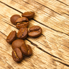 Obraz na płótnie Canvas Coffee beans on old wooden table - 1 to 1 ratio
