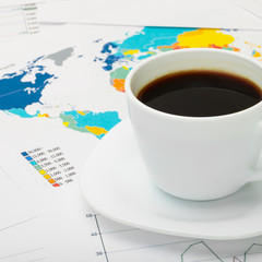 Black coffee cup over world map - 1 to 1 ratio