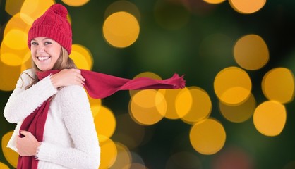 Composite image of happy blonde in winter clothes