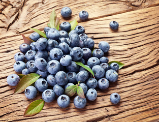 Blueberries over old wooden table.