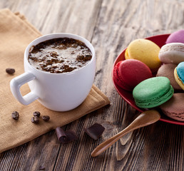 Cup of hot cocoa and french macaron.