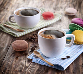 Cup of coffee and french macaron.