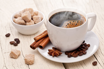 Cup of hot coffee on an old wooden table.