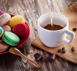 Cup of coffee and french macaron.