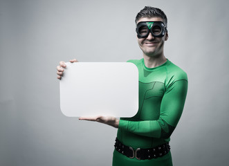 Superhero holding a blank sign