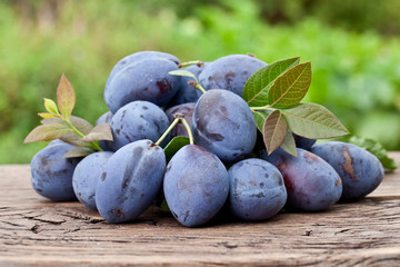 Plums on an old wooden table.