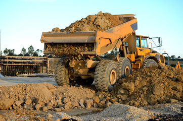Dump truck removing the rubble of a demolition © iron_man