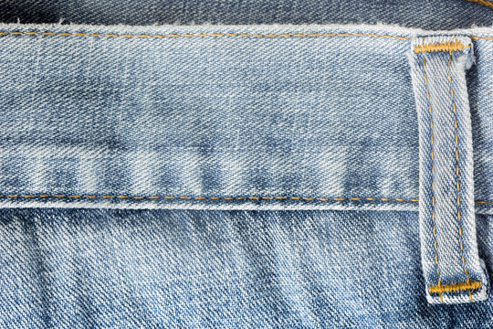 Closeup old blue jeans as background.