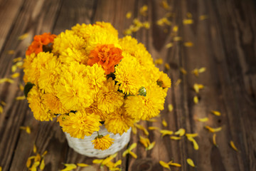 Beautiful bouquet of chrysanthemums flowers in wicker basket, on