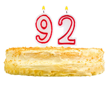 birthday cake with candles number ninety two isolated on white