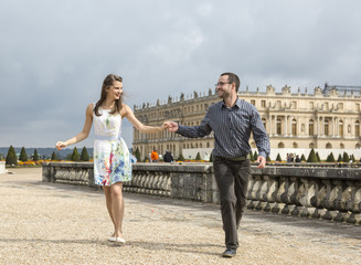 Happy Young Couple Running Holding Hands