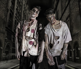 Two male zombies standing in empty city street