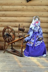 Female mannequin spinning yarn