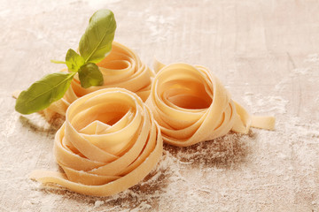 Rolled Flat Fresh Fettuccine Pasta on Table