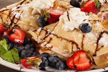 Pancakes with cream and strawberries