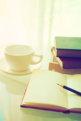 open book with cup of coffee in vintage light tone color