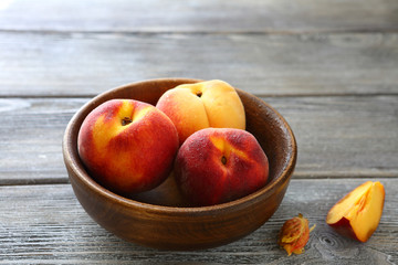 Fototapeta na wymiar three sweet peaches in a bowl