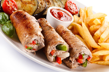 Wrapped pork chop, boiled potatoes and vegetables