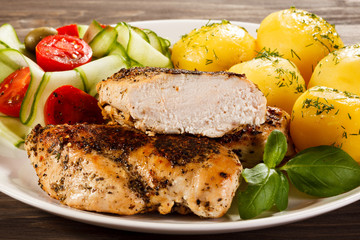 Fried chicken fillet, boiled potatoes and vegetable salad