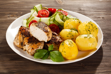 Fried chicken fillet, boiled potatoes and vegetable salad