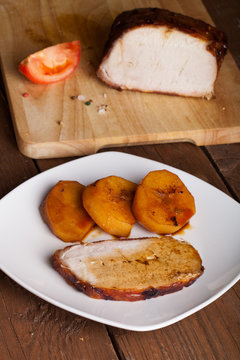 pork with potatoes on old wooden table