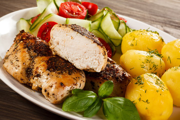 Fried chicken fillet, boiled potatoes and vegetable salad
