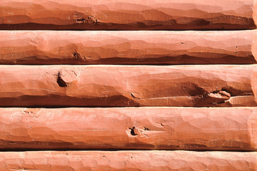 Wooden wall made of big logs - may be used as a background. 