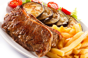 Grilled steak, French fries and vegetables